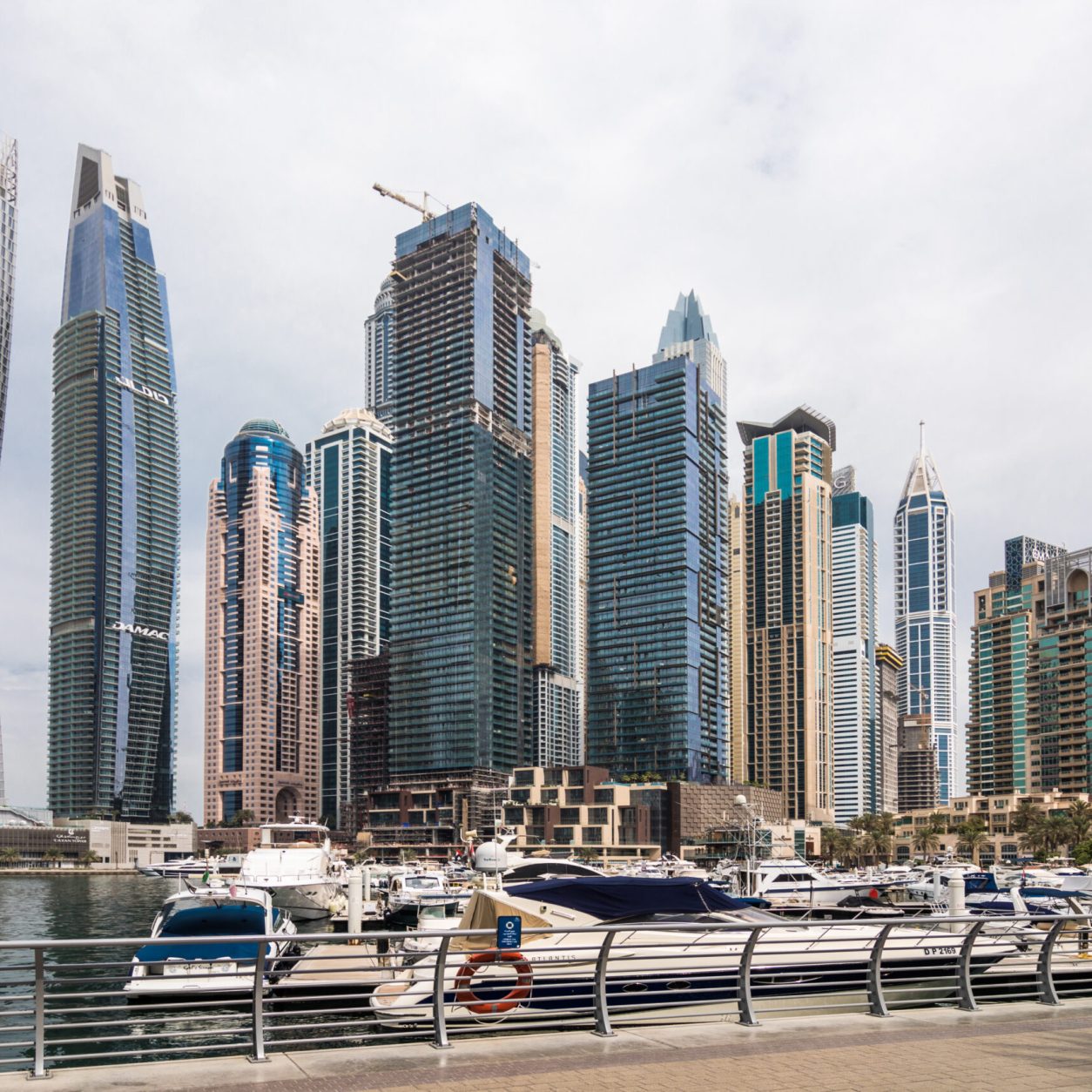 DUBAI, UAE - OCTOBER 2018: View of modern skyscrapers shining in sunrise lights in Dubai Marina in Dubai.